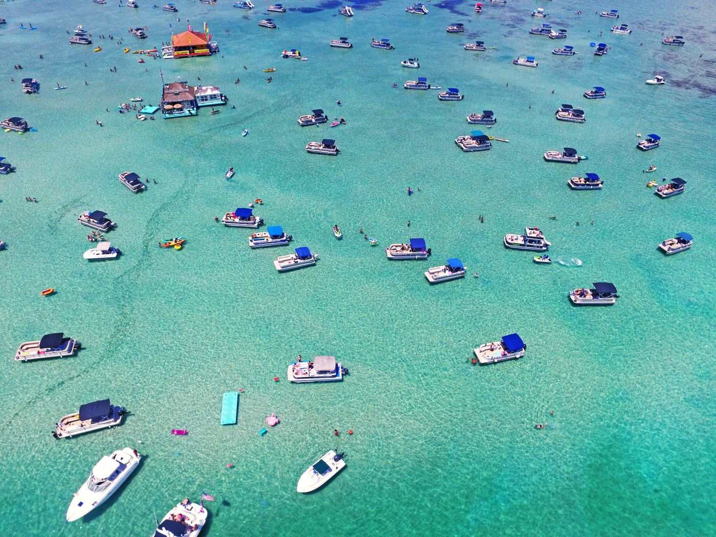 Aerial view of boats anchored on a shallow sandbar