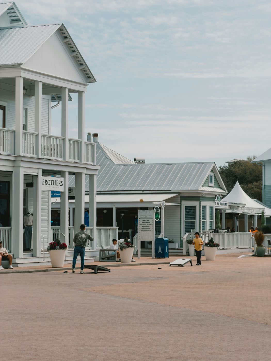 Neighbors playing cornhole in a small-town square